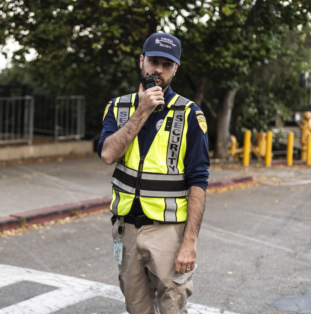Photo of a security officer using a handheld radio at the Lab.